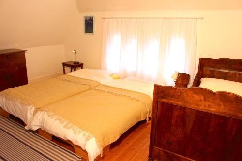 a bedroom with a large bed and a window at Villa Beckmann in Gengenbach