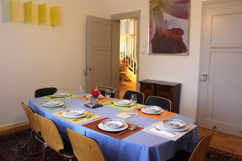 a dining room table with a blue table cloth at Villa Beckmann in Gengenbach