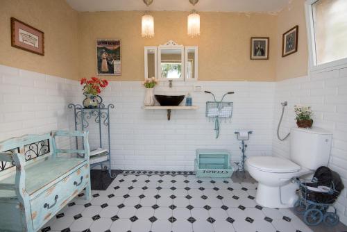 a bathroom with a bed and a toilet in it at Sea of Galilee Panoramic View in Moshav Ramot