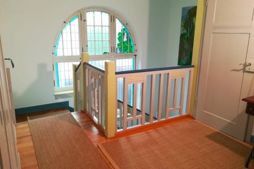 a room with a staircase with a window and a door at Villa Beckmann in Gengenbach