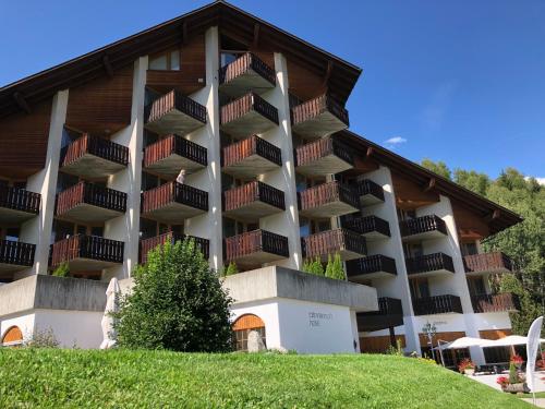 a large building with balconies on the side of it at Catrina Hotel in Disentis