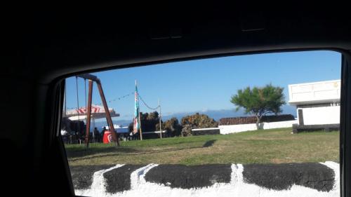 a view of a playground from a car window at Azores Hibiscus House - Mountain and Sea in São Roque do Pico