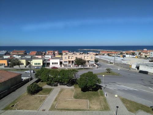 a view of a city with the ocean in the background at Farol Nascente in Lavra