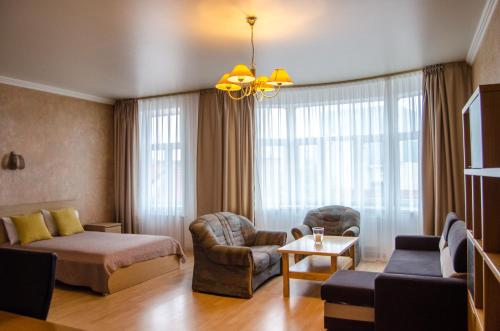a hotel room with a bed and a living room at City Inn Riga Apartment, Old Town History Heritage with parking in Rīga