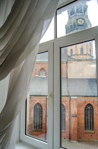 an open window with a view of a brick building at City Inn Riga Apartment, Old Town History Heritage with parking in Rīga