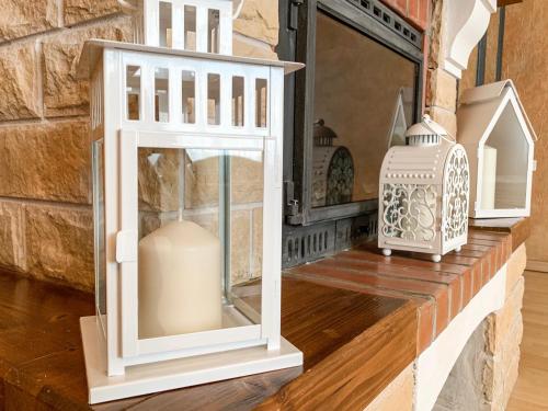 two white lanterns and a vase on a shelf at City Inn Riga Apartment, Old Town History Heritage with parking in Rīga