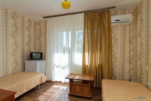 a hotel room with two beds and a window at Пансионат Химик in Novomikhaylovskiy