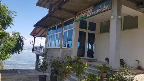 a seafood restaurant with a view of the water at ROOMS balani in Shkodër