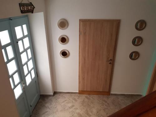 an empty room with a door and plates on the wall at Piraneska in Piran