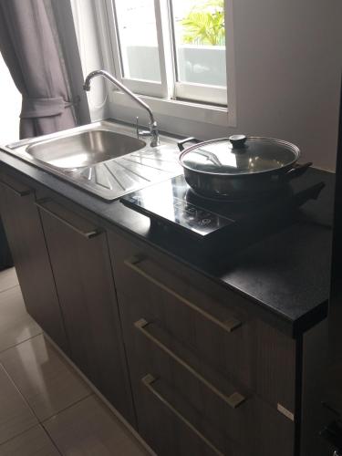 a kitchen counter with a sink and a bowl on it at Asia's Beach Apartments in Sattahip