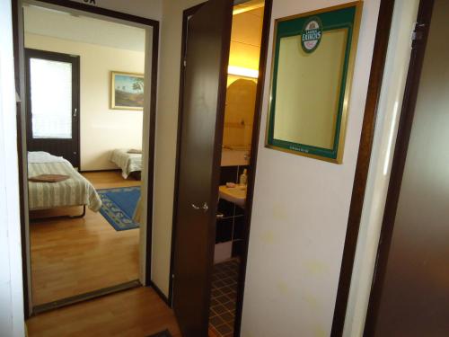a door leading into a room with a bedroom at Hotel Lamminpää in Tampere