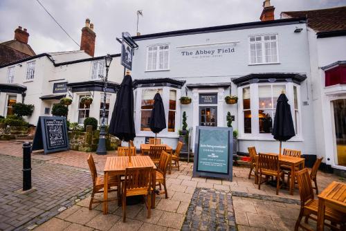 a restaurant with tables and chairs in front of a building at Abbey Fields By Chef & Brewer Collection in Kenilworth