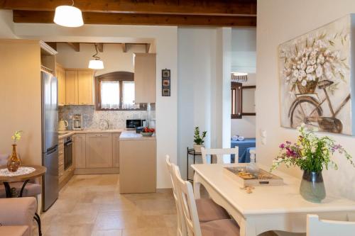 a kitchen and dining room with a table and chairs at Cretan Minoan Apartments in Zákros