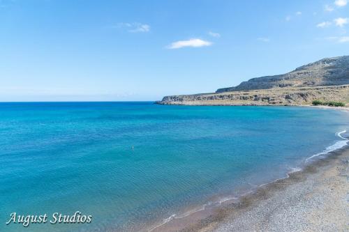 a view of a beach with blue water at Cretan Minoan Apartments in Zákros