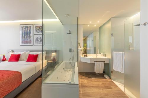 a hotel room with a large bed and a large mirror at Meliá Maputo Sky in Maputo