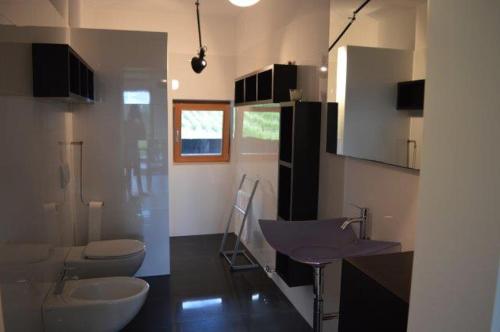 a bathroom with two toilets and a sink at Weingut Bachgütl in Cermes