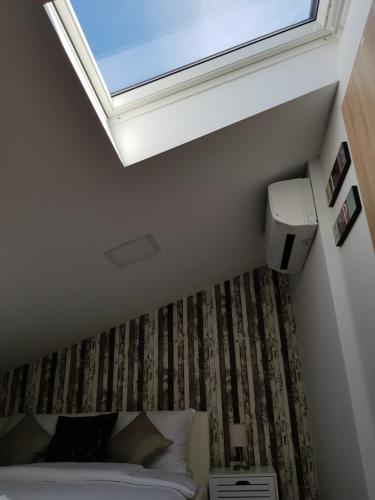 a bedroom with a bed and a skylight at Piraneska in Piran