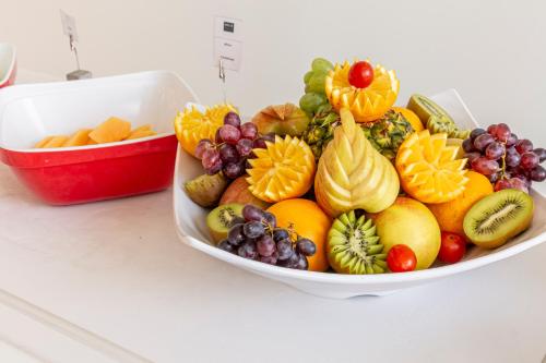 a bowl filled with fruits and vegetables on a counter at Meliá Maputo Sky in Maputo