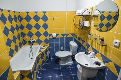 a bathroom with a sink and a toilet and a mirror at Hotel Dejmalik in Litoměřice