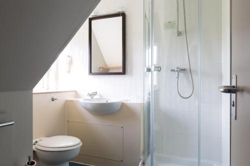 a bathroom with a toilet and a sink and a shower at White Hart by Chef & Brewer Collection in Chalfont Saint Giles