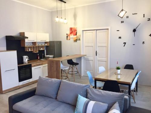a living room with a couch and a table and a kitchen at Rebel Apartament in Bielsko-Biała