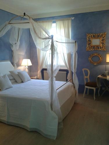 a bedroom with a white bed with a canopy at Casa Soleluna B&B in Cortona