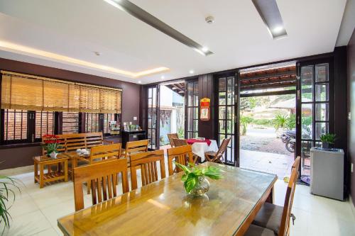 a dining room with a table and chairs at Pearl Beach Homestay - Cua Dai Beach, Hoi An in Hoi An