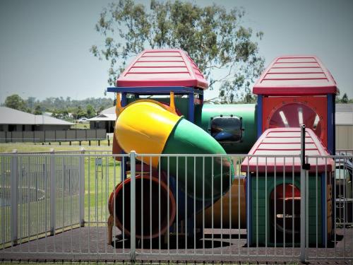a playground with two play equipment in a park at Pittsworth Motor Inn in Pittsworth