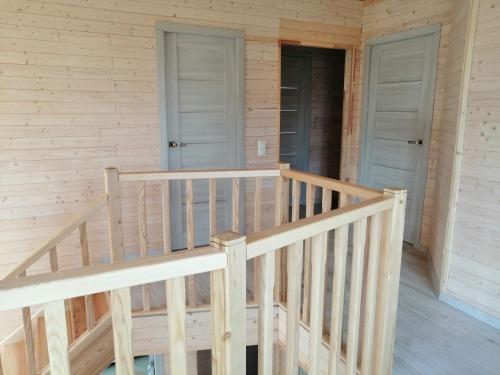 a wooden staircase in a cabin with two doors at Igor House in Jūrmala