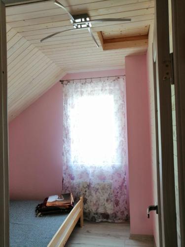 a room with a window and a bed and a curtain at Igor House in Jūrmala