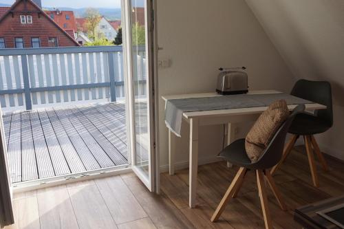a small table with a microwave on a balcony at Ferienhaus Hundertmorgenfeld 33 in Wernigerode