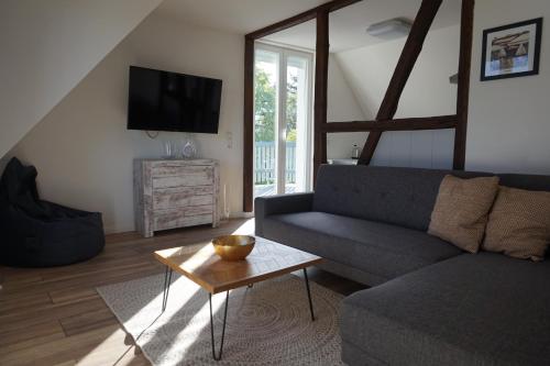 a living room with a couch and a table at Ferienhaus Hundertmorgenfeld 33 in Wernigerode