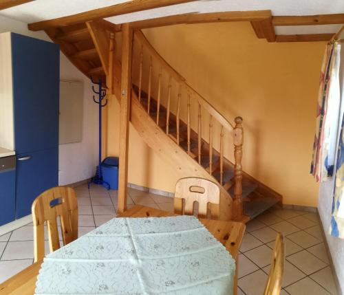 a dining room with a table and a staircase at Ferienwohnung Gross B in Schleiden