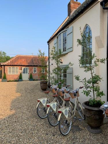 a group of bikes parked outside of a house at Holly Lodge Boutique B&B in Thursford