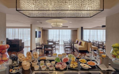 a buffet of food on a table in a hotel lobby at Kempinski Hotel Gold Coast City in Accra