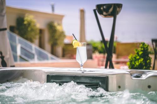 a drink in a bathtub with a lemon in it at Riad Enchanté in Marrakesh