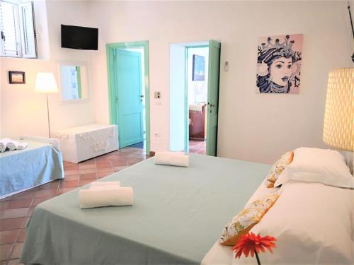 a bedroom with a bed with two pillows on it at Villa Mareblu Luxury Holiday Apartment direttamente sul mare in Stromboli