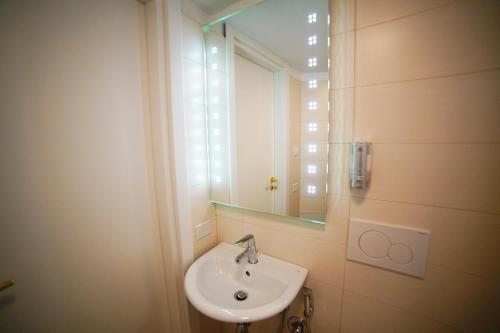 a bathroom with a sink and a mirror at L' Infinito dei Sassi in Matera