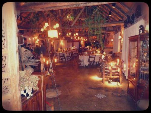a room with a restaurant with tables and chairs at Pueblo Chico Agroturismo Hotel in La Floresta
