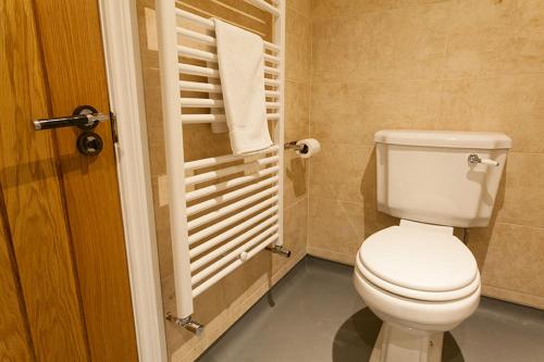 a bathroom with a toilet and a towel rack at Nelthorpe Arms in Barton upon Humber