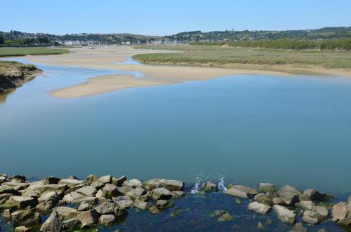 an aerial view of a beach with rocks and water at Les Chambres des Gites des Isles in Barneville-Carteret