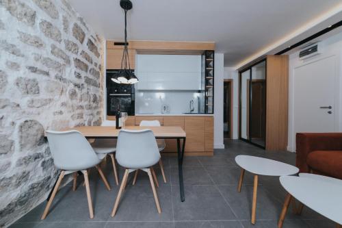 a kitchen and dining room with a table and chairs at Apartments Trifunovic Old Town in Budva