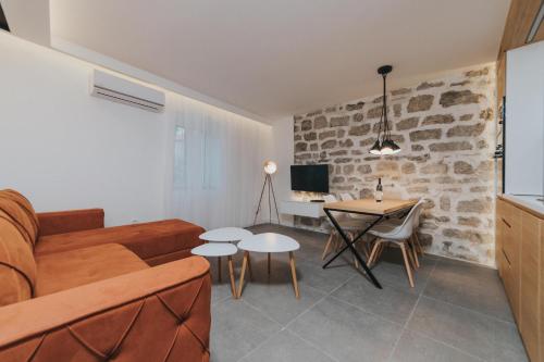 a living room with a couch and a table at Apartments Trifunovic Old Town in Budva