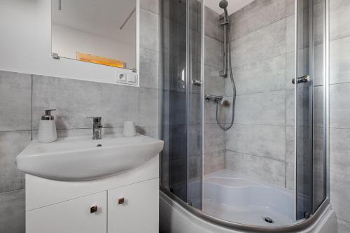 a bathroom with a shower and a sink and a shower at Osada Chłapowo in Władysławowo