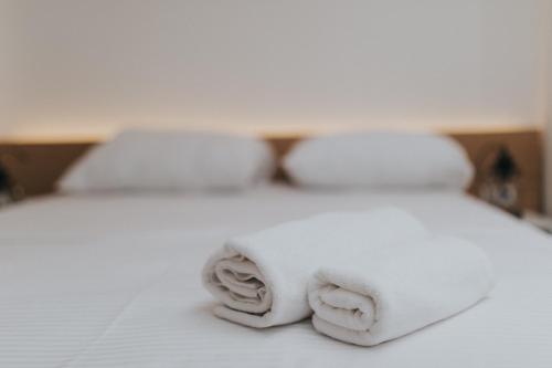 a pile of towels sitting on top of a bed at Apartments Trifunovic Old Town in Budva