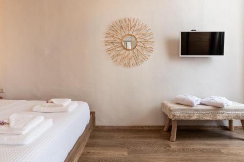 a hotel room with two beds and a tv at Geant Suites Mykonos in Mikonos