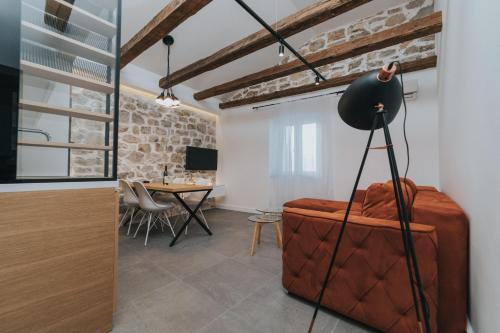 a living room with a table and a suitcase at Apartments Trifunovic Old Town in Budva