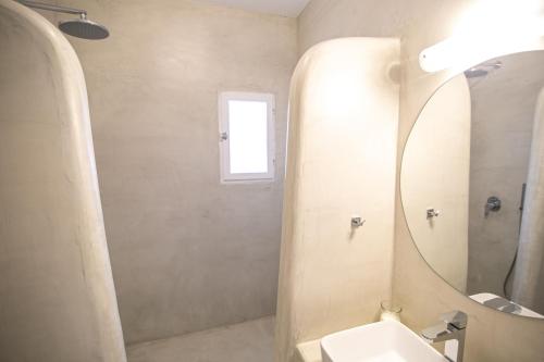 a bathroom with a sink and a mirror at Apanomeria Boutique Residence in Oia