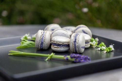 a group of macaroons on a table with flowers at Horse & Jockey Hotel in Horse and Jockey