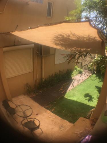 a view of a yard from a window at Magnificant Studio/Zimmer Zichron in Zikhron Ya‘aqov